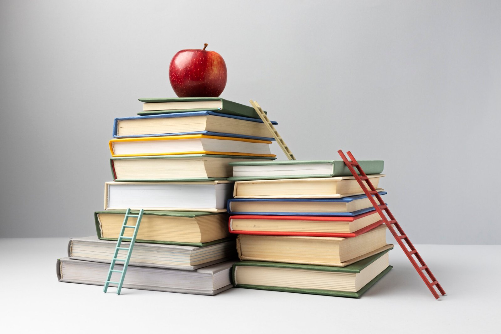 front-view-stacked-books-ladders-apple-with-copy-space-education-day
