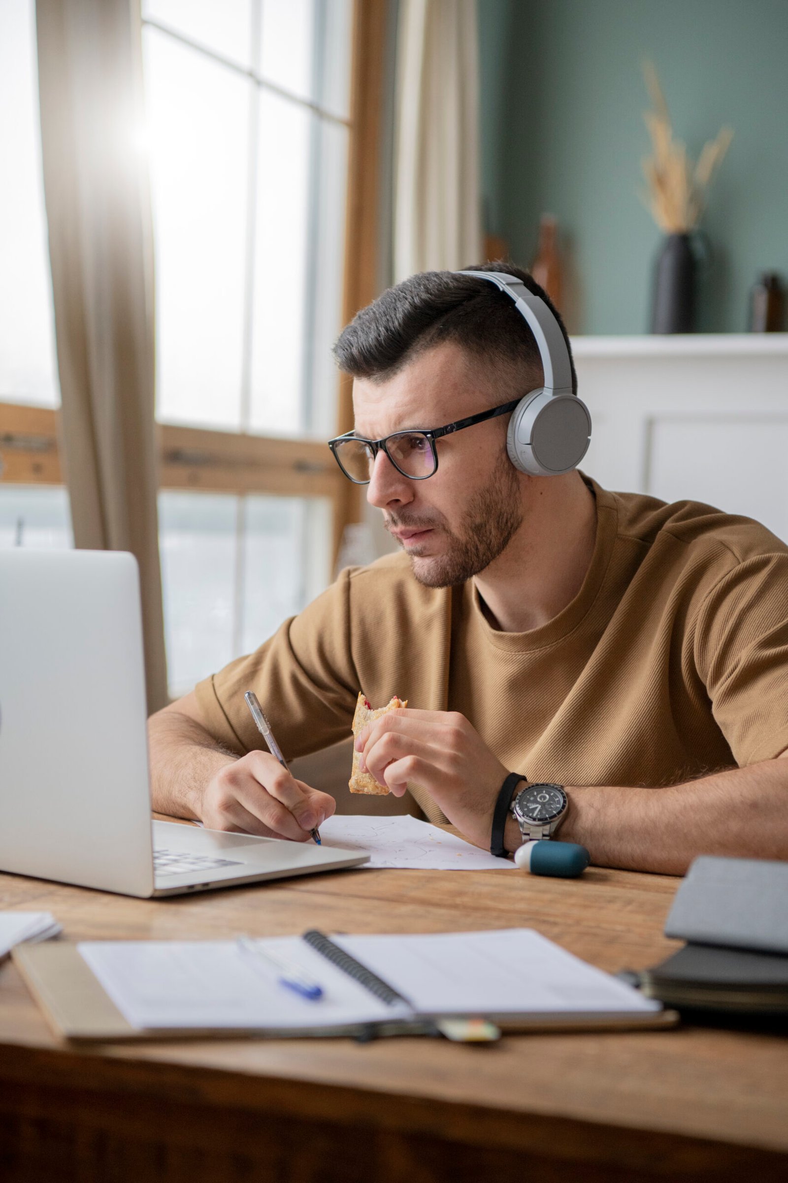 young-man-studying-library-using-laptop